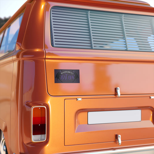 Close-up of an orange vehicle with a visible brand logo on the door.