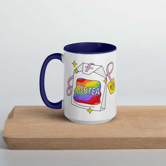 White 15oz ceramic LGBTea mug with dark blue handle and interior, featuring a rainbow tea bag illustration with pink ribbons and sparkles.