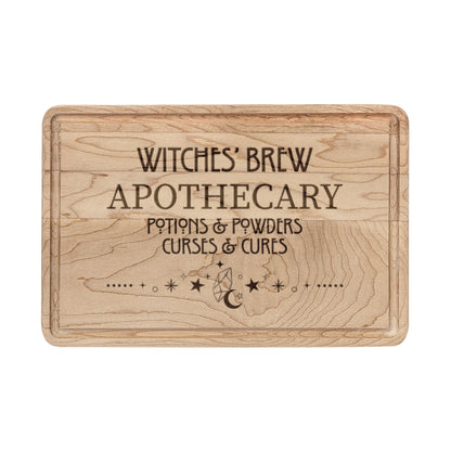 Witches' Brew Apothecary Engraved Wooden Cutting Board by Spinsterly Co in Walnut with drip ring and carved text