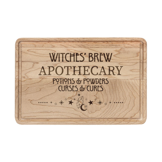 Witches' Brew Apothecary Engraved Wooden Cutting Board by Spinsterly Co in Walnut with drip ring and carved text