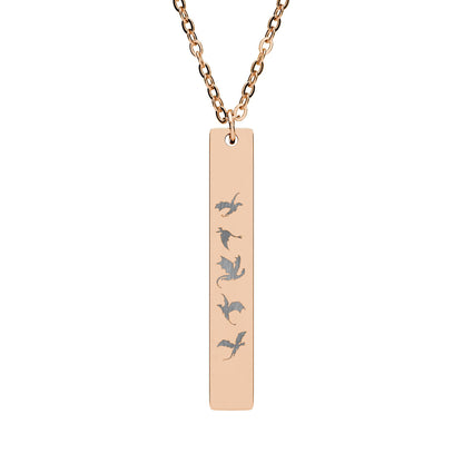 Five Dragons in Flight Engraved Vertical Bar Necklace by Spinsterly Co in 18K Gold PVD coating with five dragon silhouettes