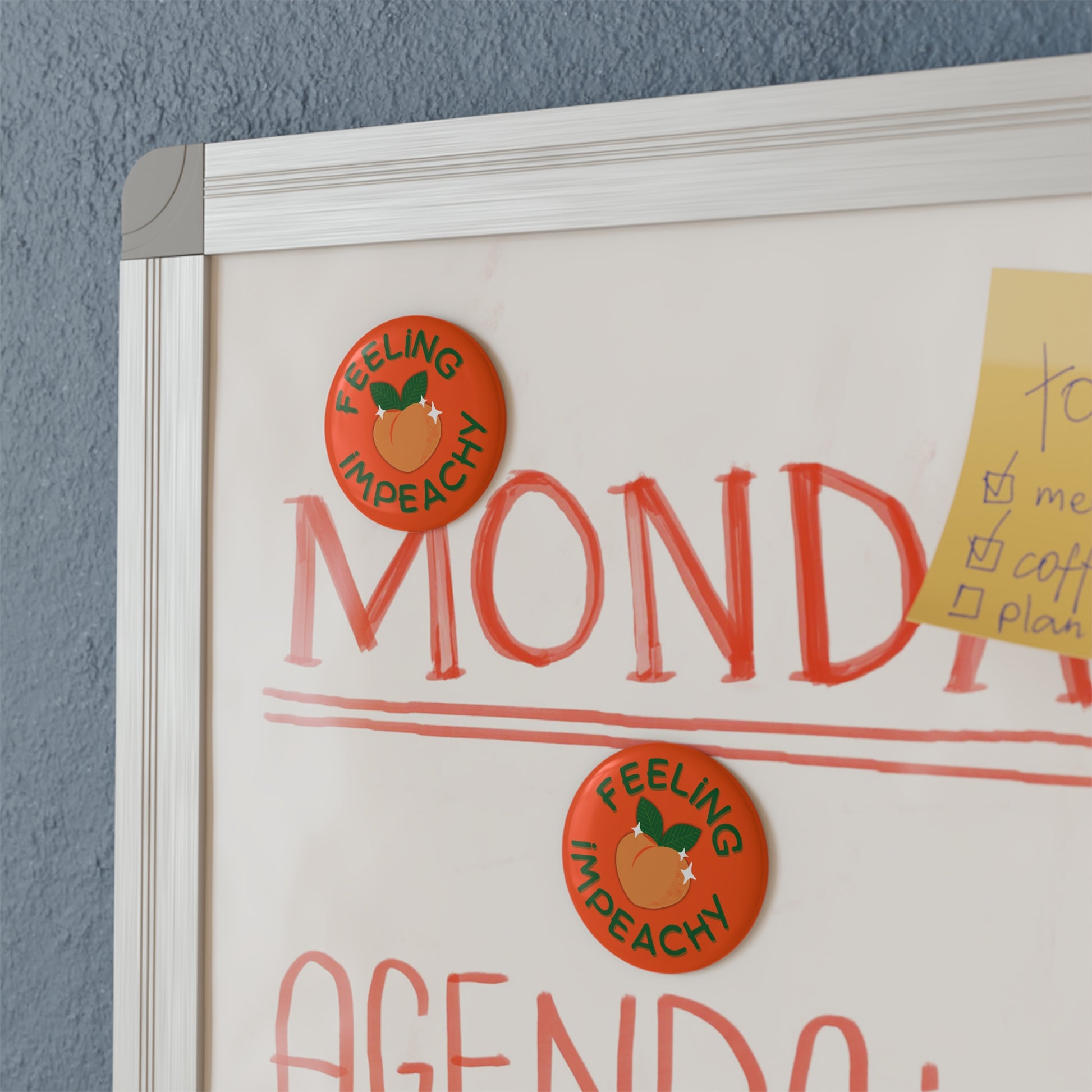 Feeling Impeachy Button Magnet by Spinsterly Co, round orange button-style fridge magnet on a cabinet