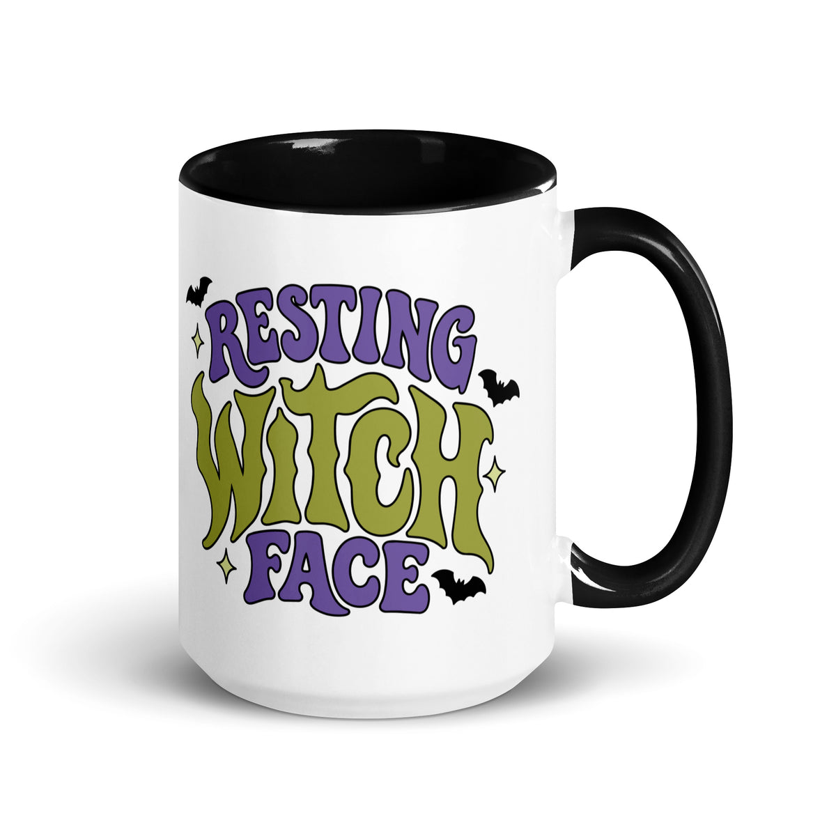 A white ceramic mug with a black interior and handle, featuring the text 'RESTING WITCH FACE' in purple and green gothic lettering with small bat illustrations, on a white background.