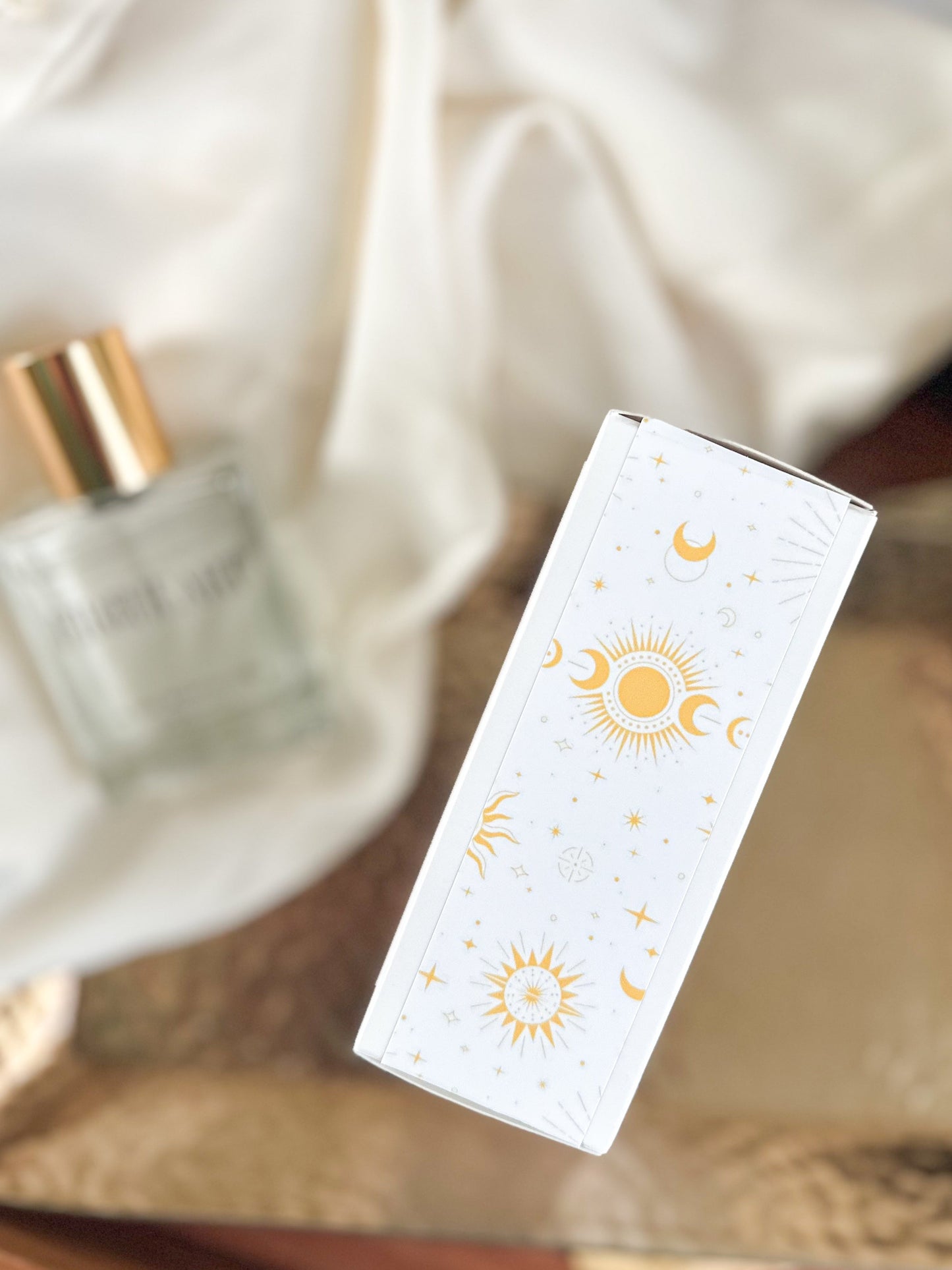 White box with sun and moon designs on a blurred background