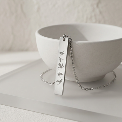 Five Dragons in Flight Engraved Vertical Bar Necklace by Spinsterly Co, stainless steel bar with five dragon silhouettes