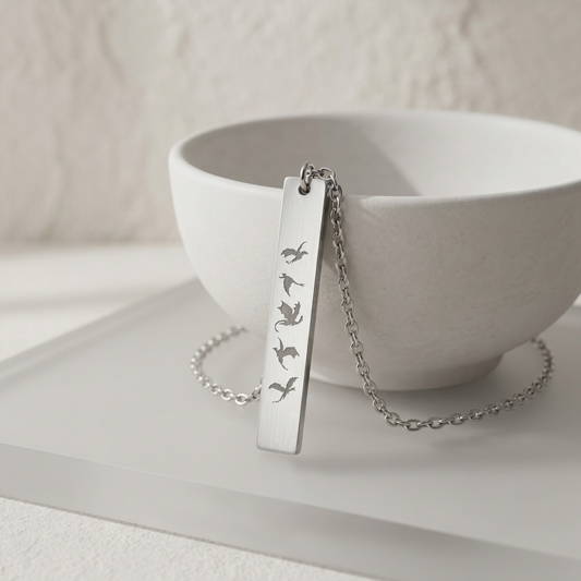 Five Dragons in Flight Engraved Vertical Bar Necklace by Spinsterly Co, stainless steel bar with five dragon silhouettes