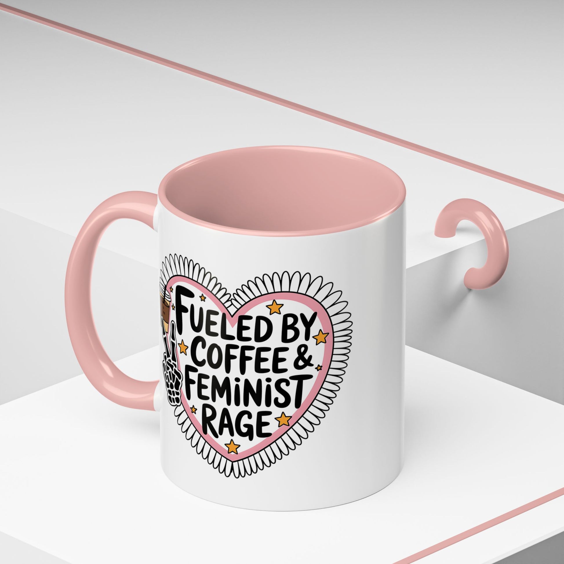 Fueled by Coffee Feminist Rage Accent Coffee Mug Spinsterly Co pink glossy ceramic mug with daisy-edged heart badge