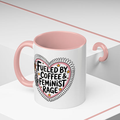 Fueled by Coffee Feminist Rage Accent Coffee Mug Spinsterly Co pink glossy ceramic mug with daisy-edged heart badge