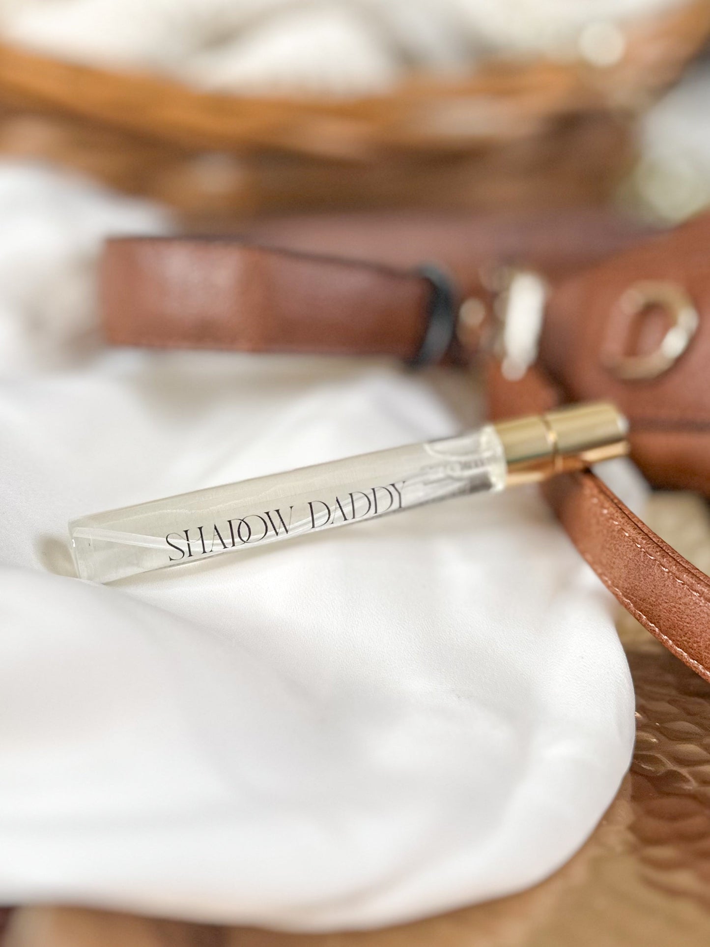 Small perfume bottle with 'Slendyt Daddy' text on a textured surface
