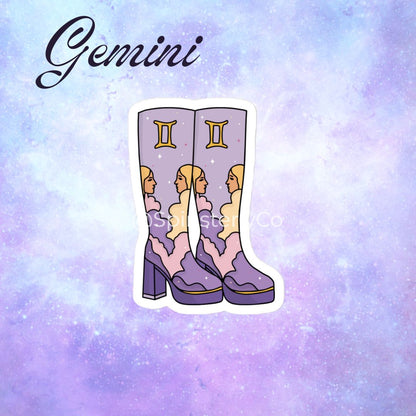 A die-cut sticker featuring a pair of purple high-heeled boots with Gemini zodiac artwork, displayed on a purple and blue galaxy background with the word 'Gemini' written at the top.