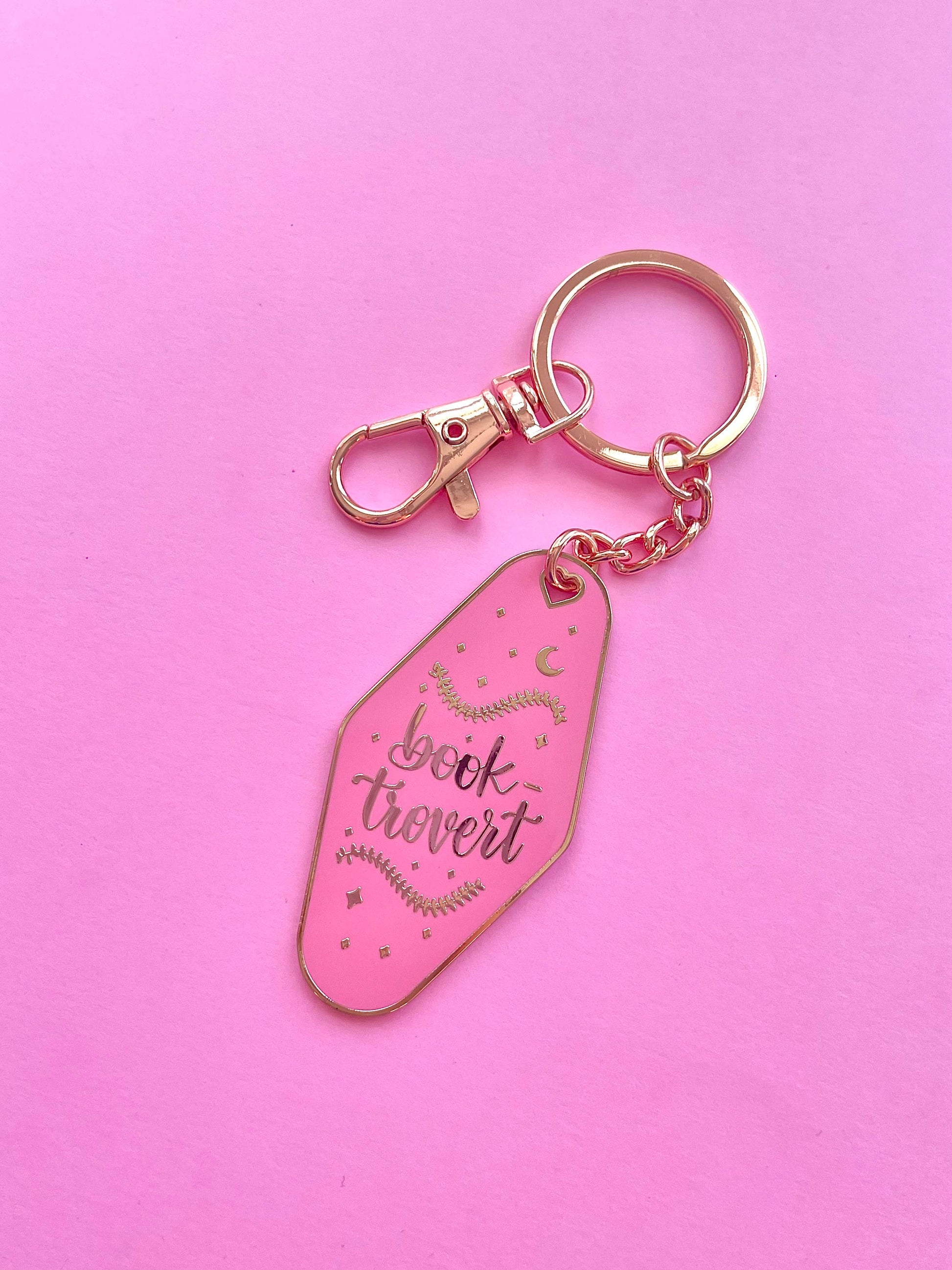 Booktrovert Hotel Keychain by Galloree Designs LLC in Pink metal with clip attachment and gold keyring
