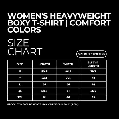 A size chart graphic for a women's heavyweight boxy T-shirt in comfort colors, showing measurements in centimeters for sizes S through 2XL on a black background.