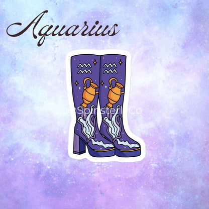 A die-cut sticker featuring a pair of purple high-heeled boots decorated with the Aquarius zodiac symbol (a golden water jug, wavy lines, and stars) on a purple and lavender galaxy background. The word 'Aquarius' is written in brown cursive at the top.