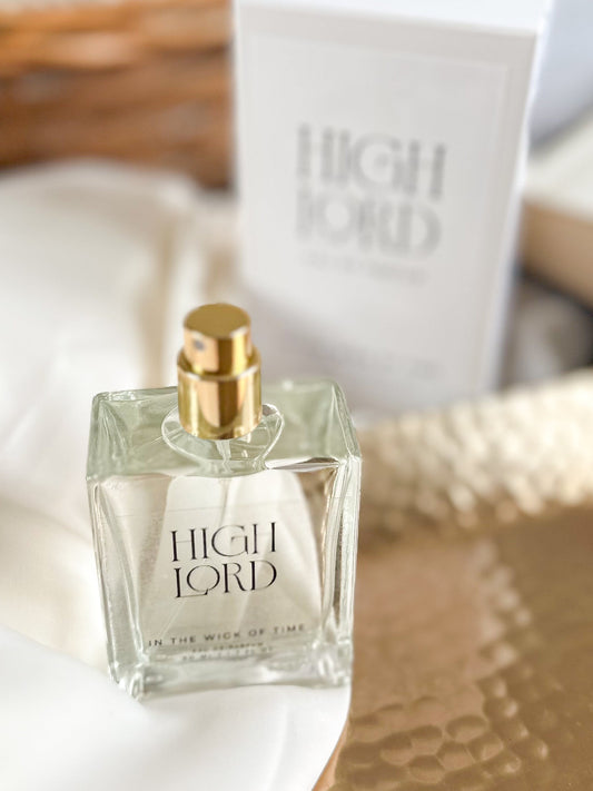 Perfume bottle labeled 'High Lord' with a gold cap on a textured surface.