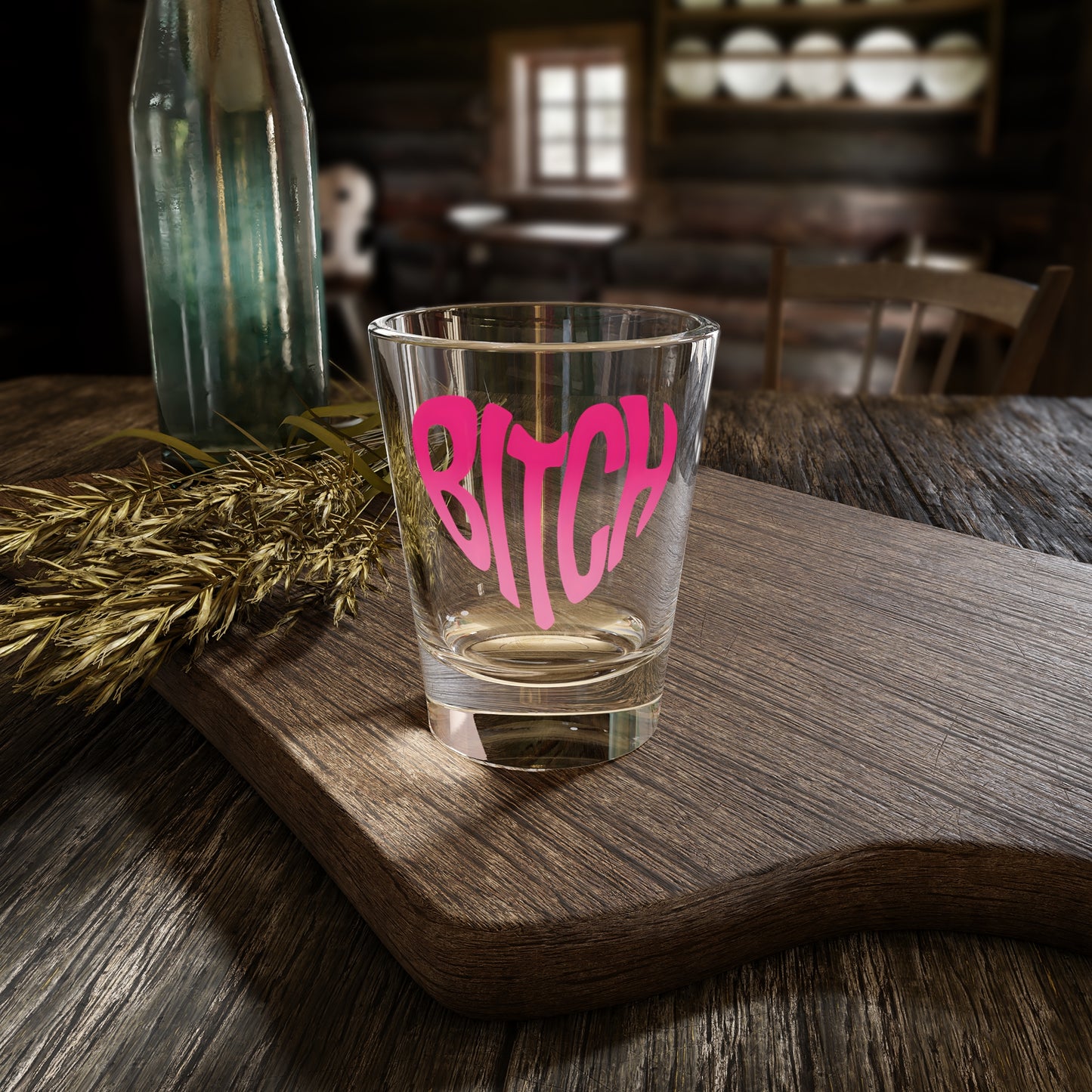 Pink Heart Bitch Script Shot Glass Spinsterly Co clear glass with pink heart BITCH lettering on a wooden table