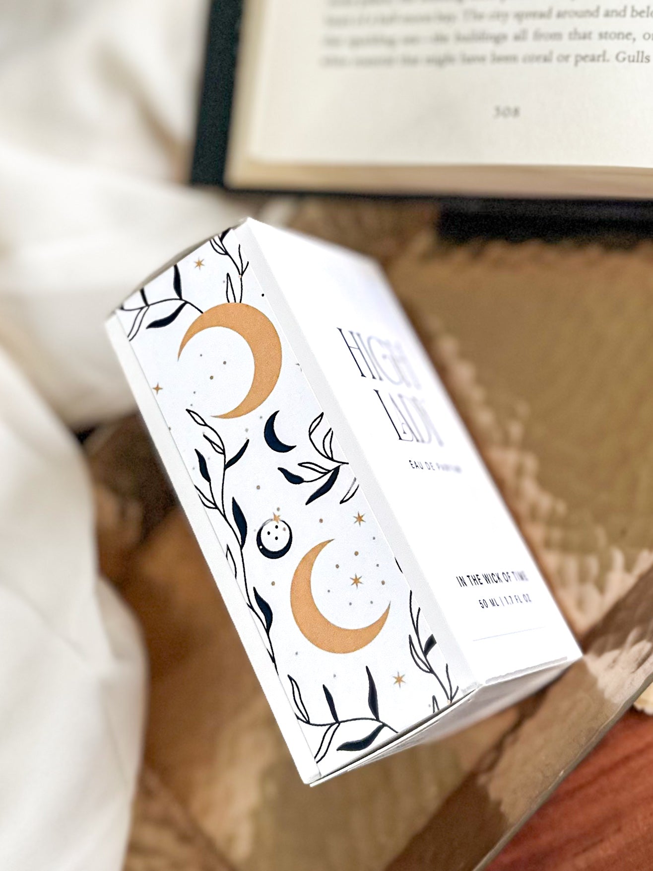 Product packaging with celestial design on a wooden surface