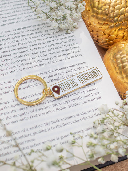 Riders Quadrant Location Keychain by Meaggie Moos hard enamel keychain with gold metal accents on book