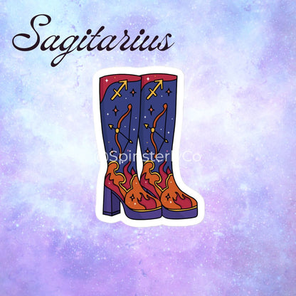 A die-cut sticker of a pair of cowboy boots with a Sagittarius theme, displayed on a purple and blue galaxy background with the word 'Sagittarius' written in script at the top.