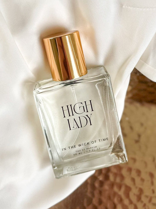 Perfume bottle labeled 'High Lady' on a textured surface