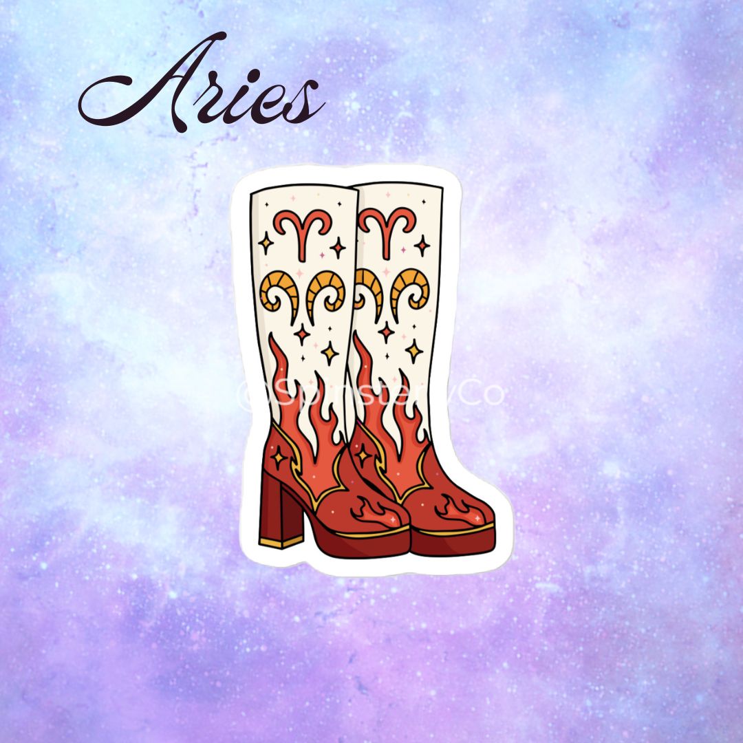 A die-cut sticker featuring a pair of white cowboy boots with red and orange flame patterns and gold Aries zodiac symbols, displayed on a purple and blue galaxy background with the word 'Aries' written in black script.