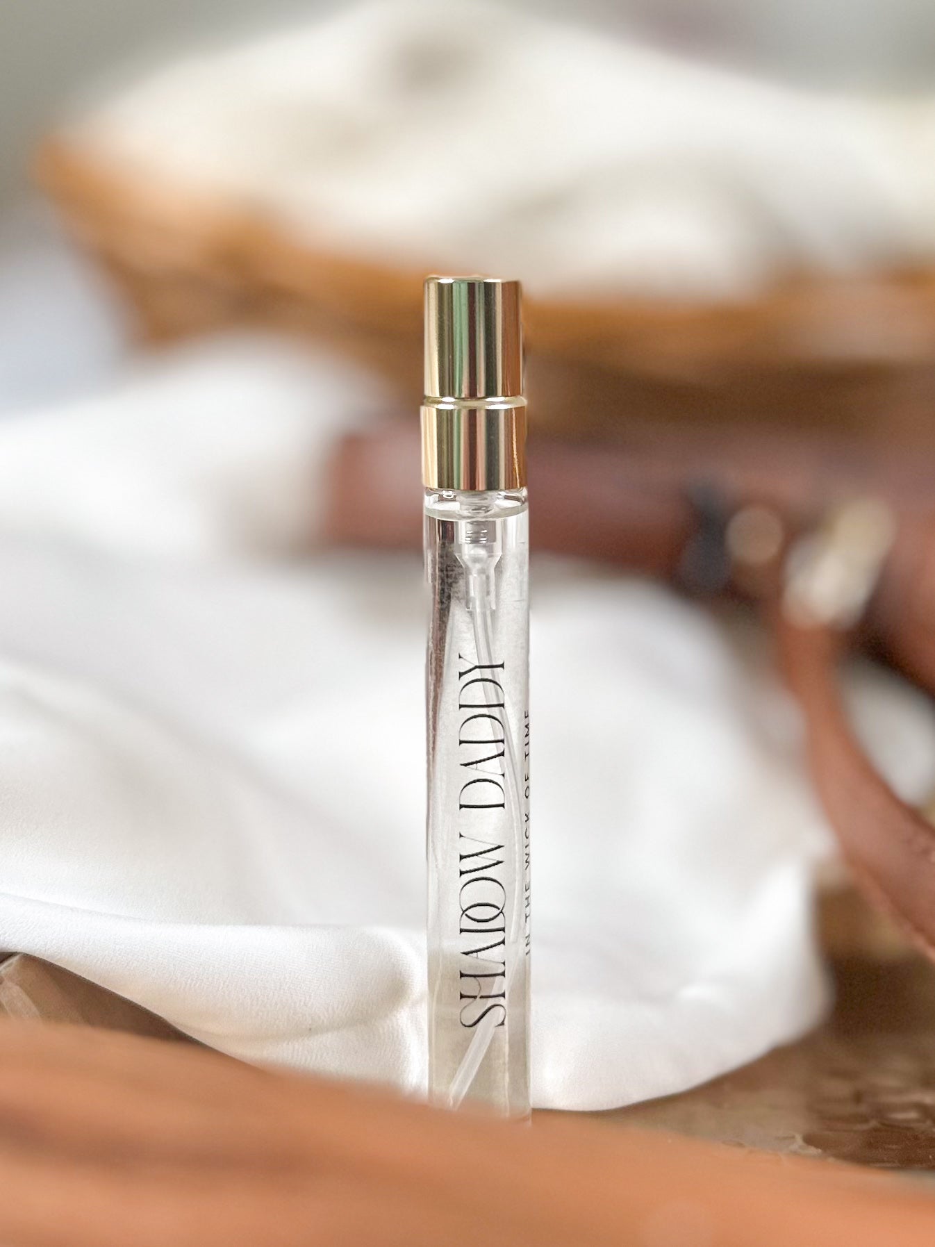 Perfume bottle with silver cap on a blurred background