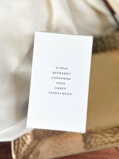 White perfume box, top view with fragrance notes on a textured surface 