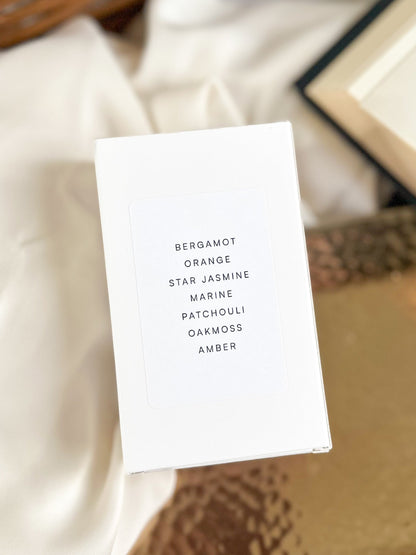 White card with text listing scents on a textured surface