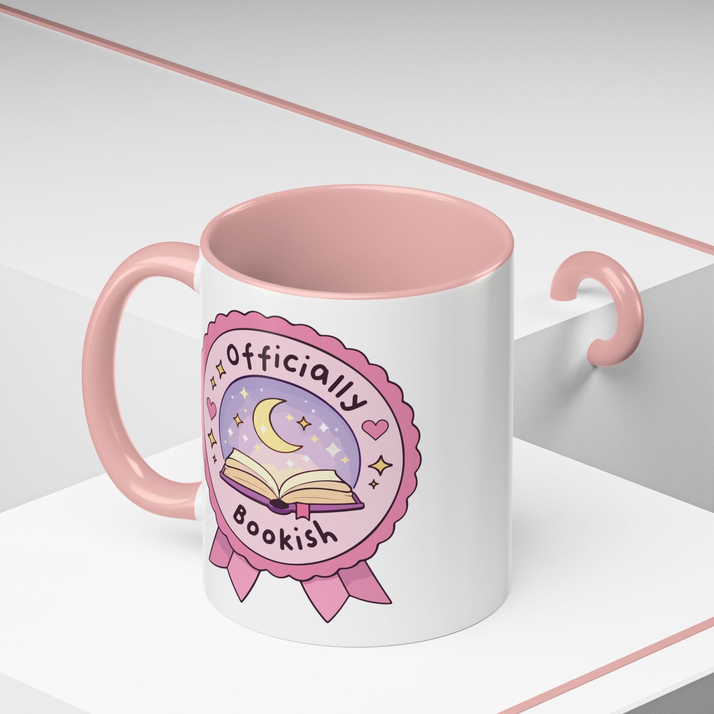 Officially Bookish Accent Coffee Mug Pink Interior by Spinsterly Co, ceramic mug with rosette badge graphic
