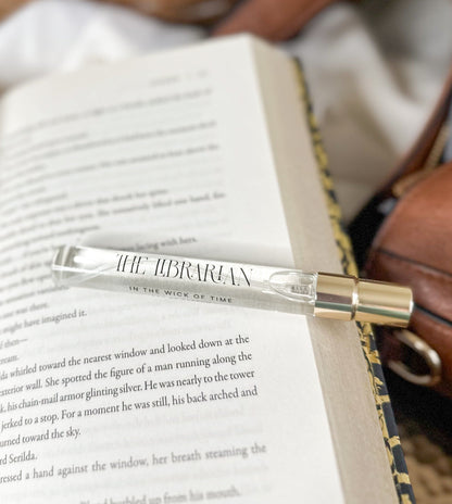 Clear pen with gold accents on an open book
