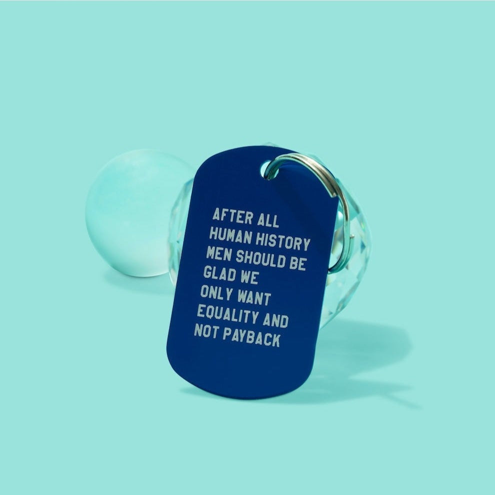 Blue keychain with white text on a light blue background