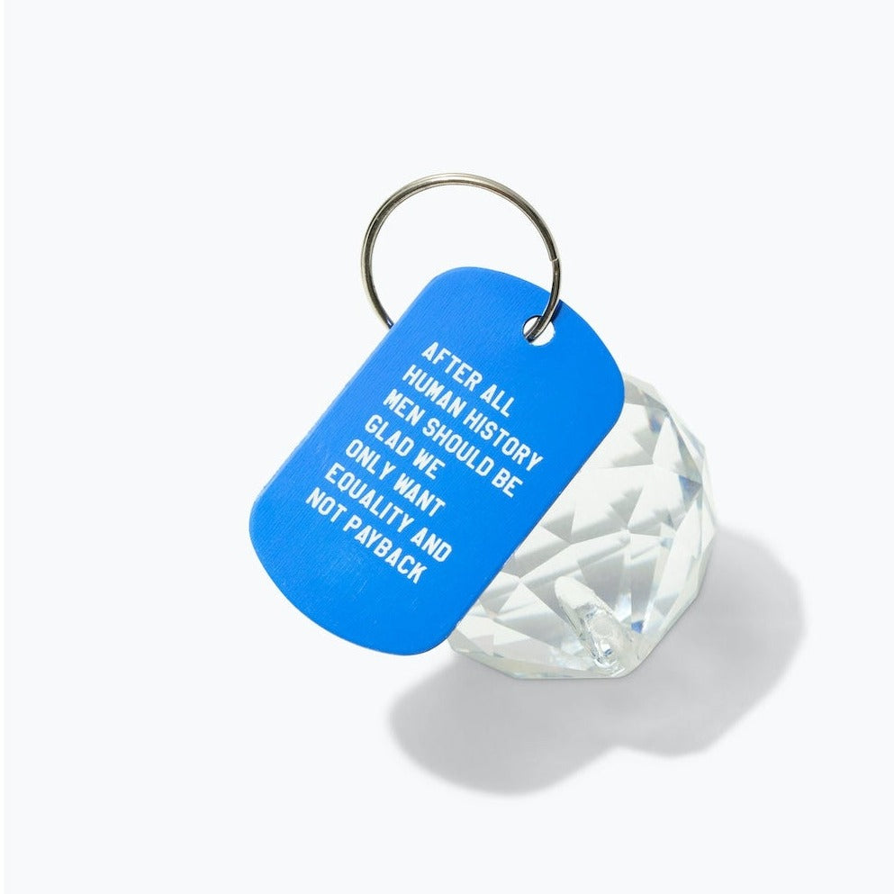 Blue keychain tag with text and a clear crystal on a white background
