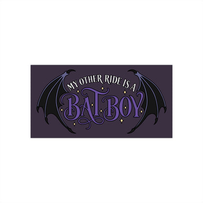 A rectangular dark purple bumper sticker featuring the phrase 'MY OTHER RIDE IS A BAT-BOY' in stylized white and purple lettering, with black bat wings and small gold star accents on a plain white background.