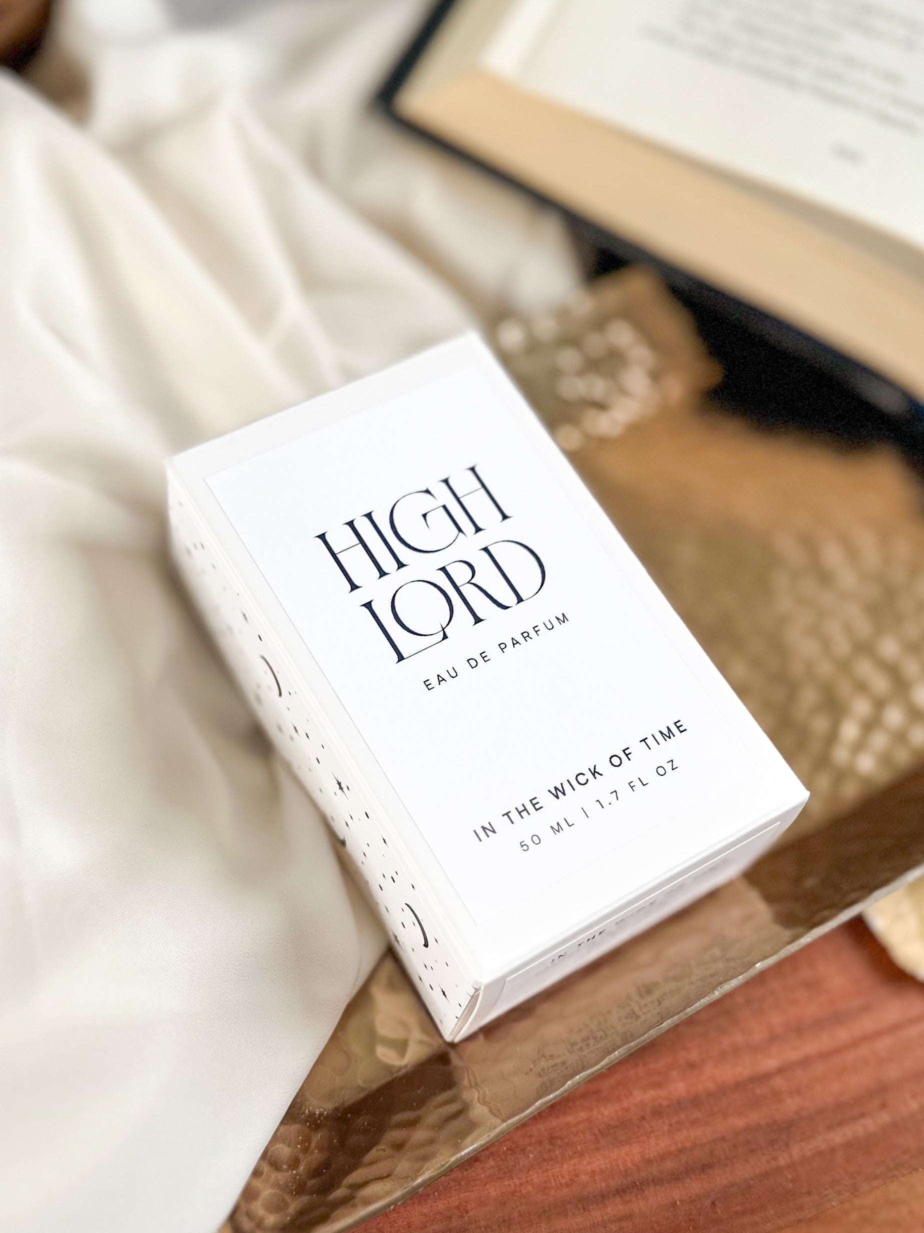Box of 'High Lord' perfume on a wooden surface with a blurred background