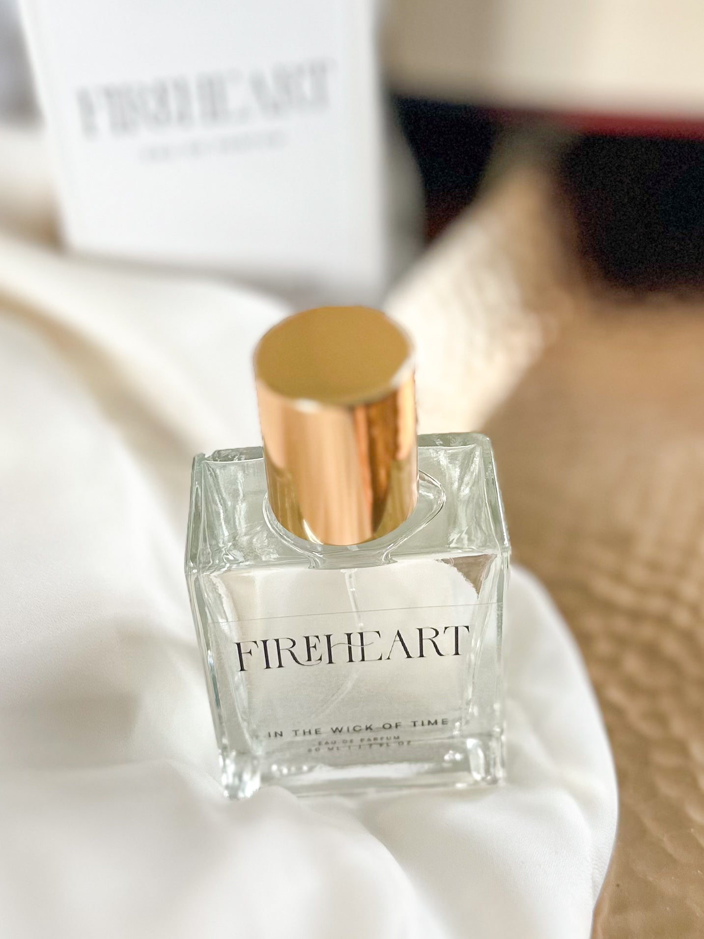 Fireheart perfume bottle with gold cap on a white surface