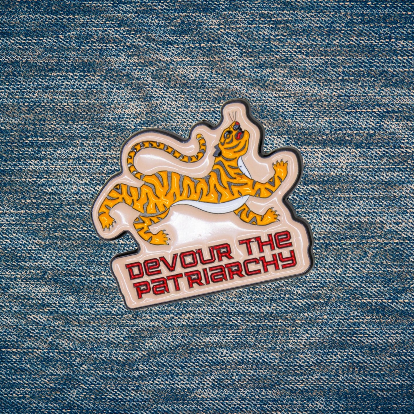 Tiger-themed patch with 'Devour the Patriarchy' text on denim fabric