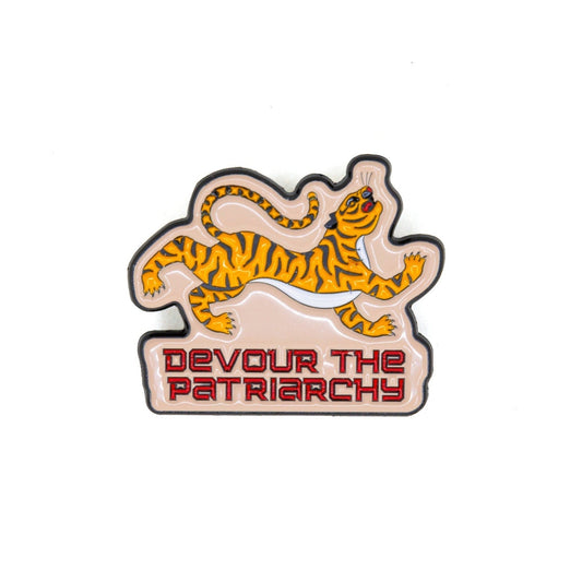 Enamel pin with a tiger design and 'Devour the Patriarchy' text on a white background