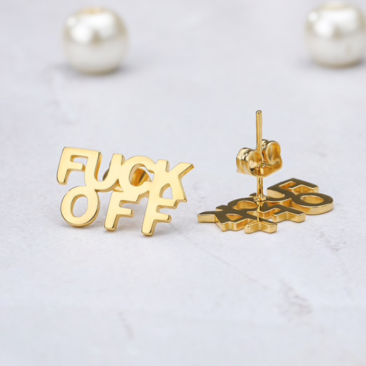 Gold earrings with censored text on a light gray background