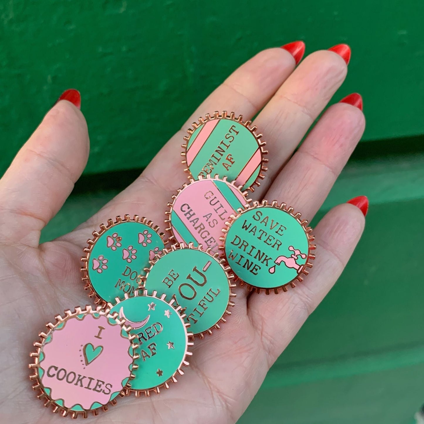 Feminist AF Enamel Pin by The Bullish Store, pink and green wheel pin with metal edges