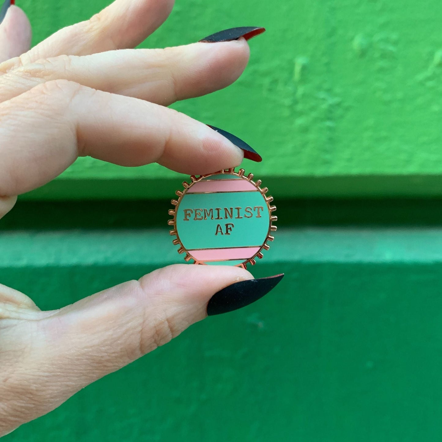 Feminist AF Enamel Pin by The Bullish Store, pink and green stripes wheel pin with metal backing