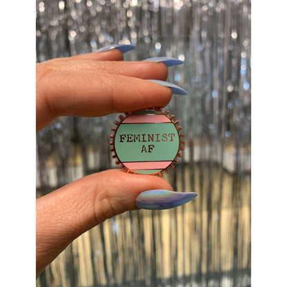 Feminist AF Enamel Pin by The Bullish Store wheel enamel pin in pink and green stripes reads Feminist AF