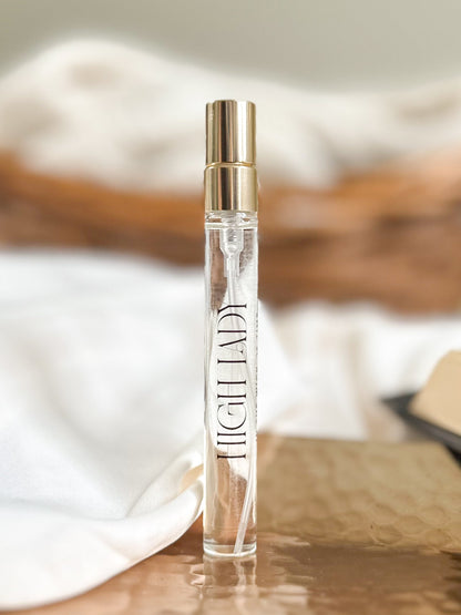 Perfume bottle labeled 'High Lady' on a wooden surface with a blurred background