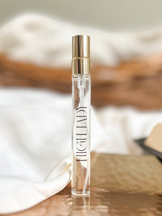 Perfume bottle labeled 'High Lady' on a wooden surface with a blurred background