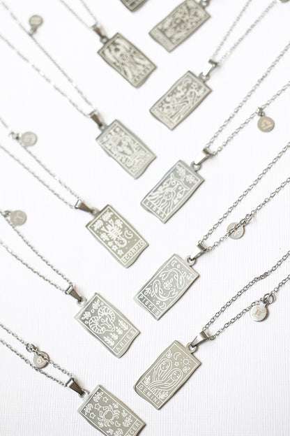 Silver necklaces with rectangular pendants on a white background