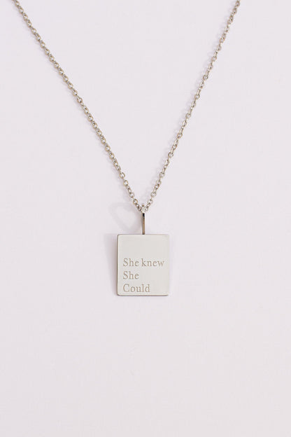 Necklace with a square pendant on a light gray background