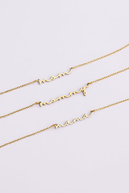 Three gold necklaces with heart designs on a light gray background
