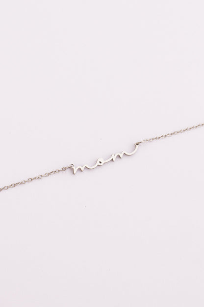 Delicate silver bracelet on a light pink background