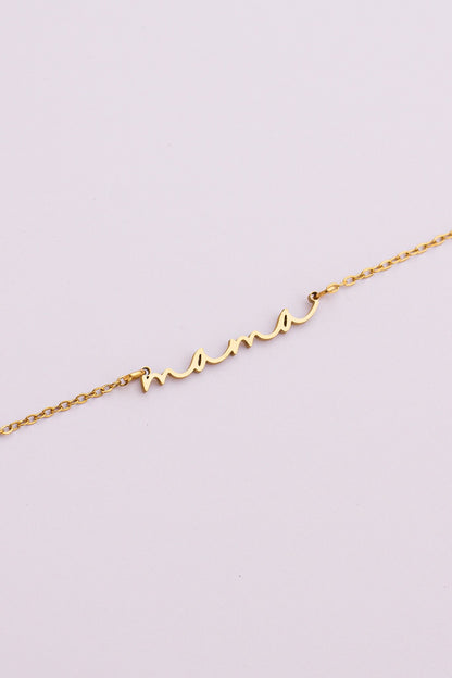 Gold bracelet with a unique design on a light purple background