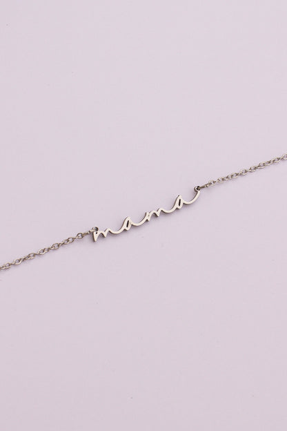 Silver bracelet with 'mom' on a light purple background
