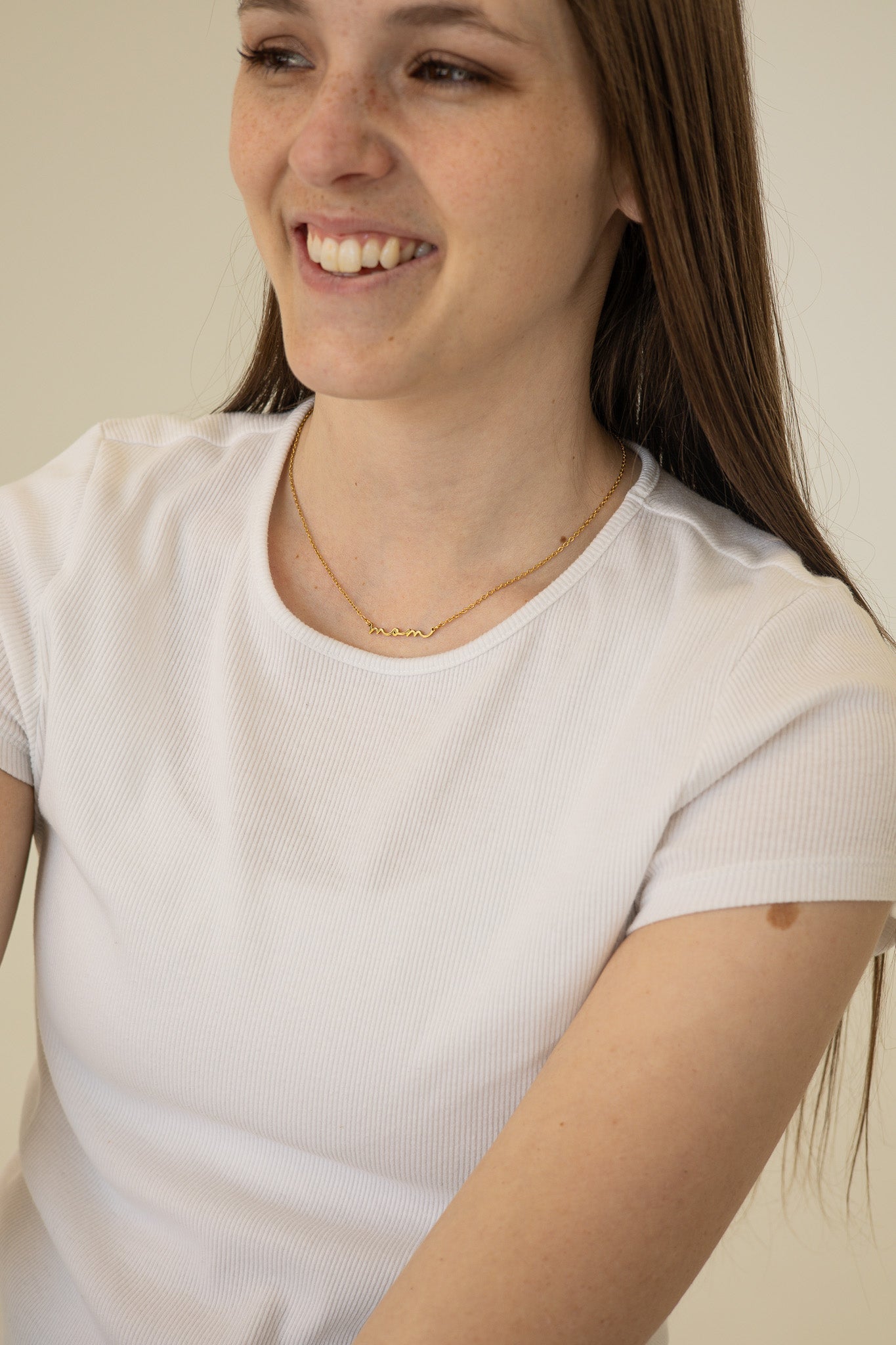 Woman wearing a white t-shirt with a plain background