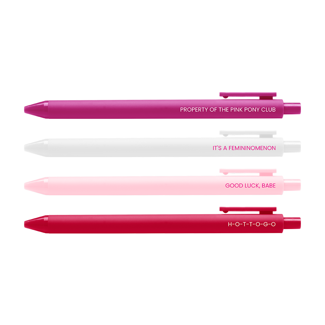 Three retractable pen-style items arranged vertically on a white background, each with its reflection below. The top pen is magenta/pink with white text reading 'PROPERTY OF THE PINK PONY CLUB'; the middle pen is white with white text reading 'IT'S A FEMINOMENON'; the bottom pen is bright pink/red with white text reading 'GOOD LUCK, BABE'.